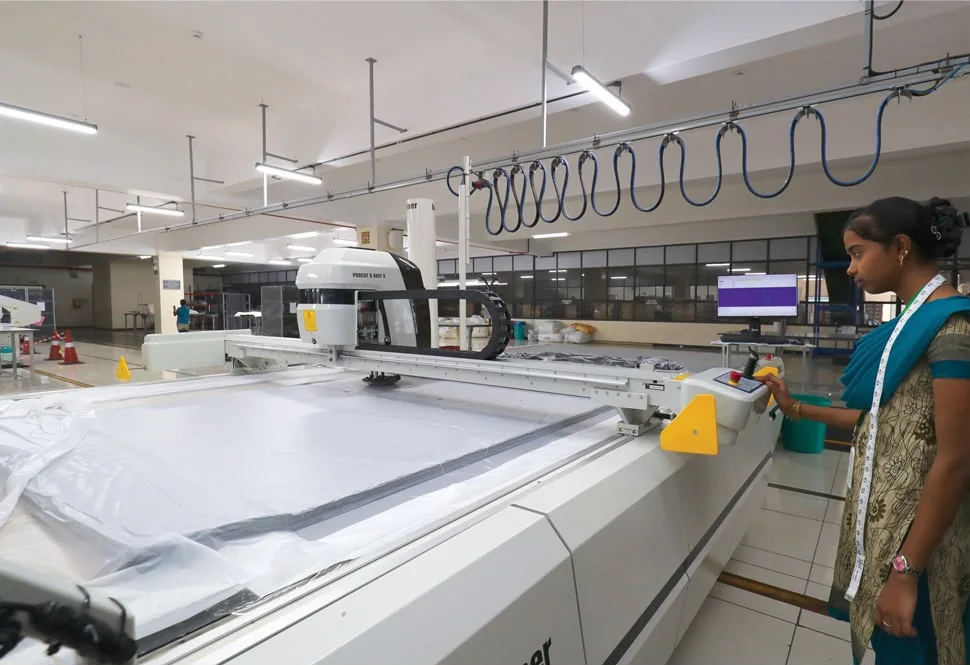 Operator controlling an automated garment cutting machine