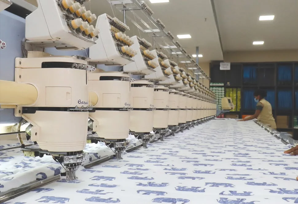 Long multi-head industrial embroidery machine producing patterned fabric